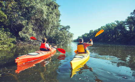 Two people kayaking on a water way in Algonquin Park.