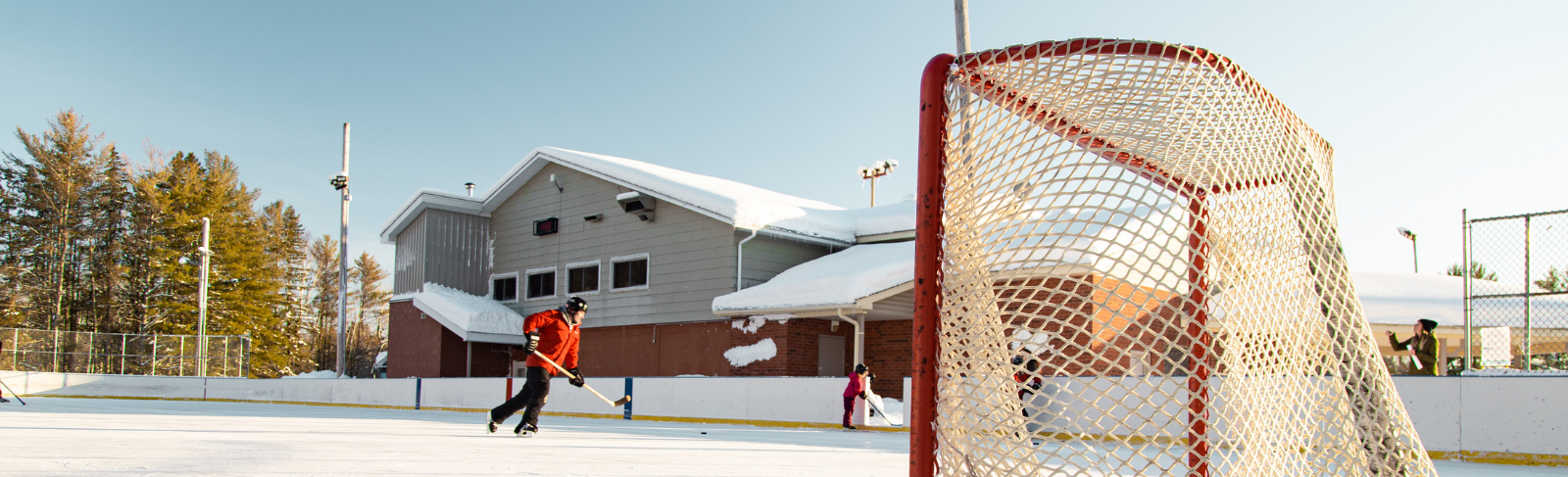 People playing hockey on an outdoor rink at Alice and Fraser.
