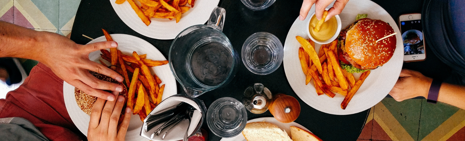 An aerial photo of people eating burgers.
