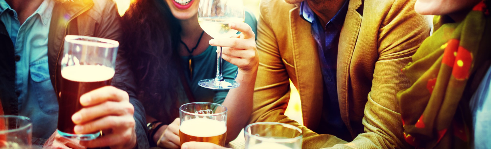 A group of people drinking beer and wine.