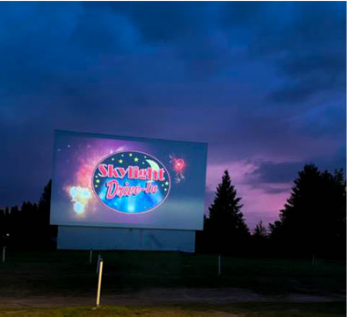 Skylight drive-in logo on the big screen at night.