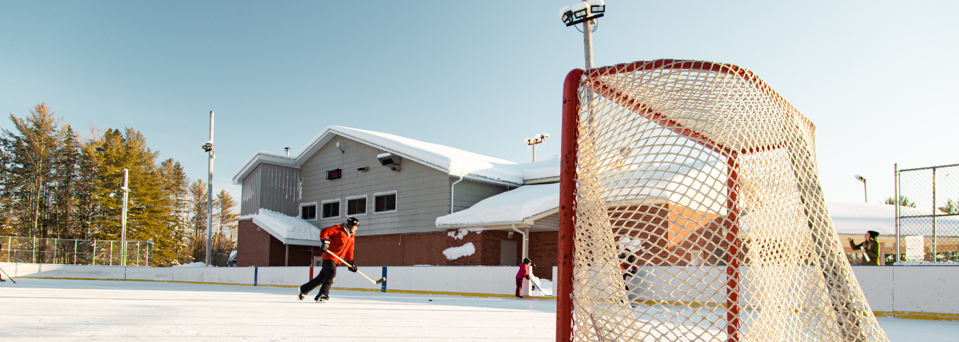 People playing hockey at the outdoor rink at Alice and Fraser.