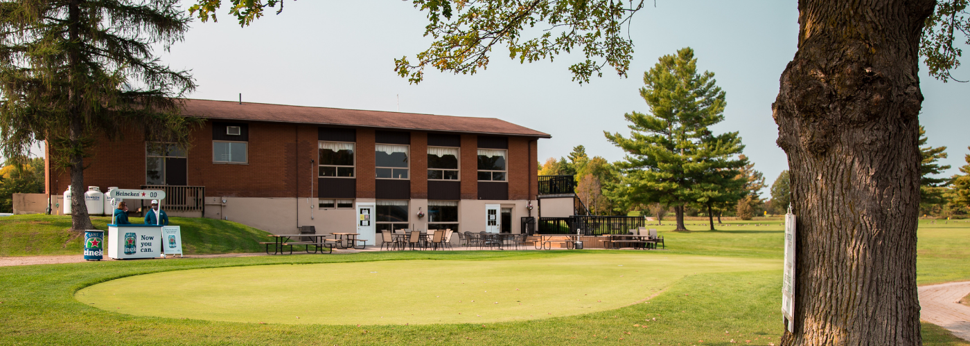 The putting green and clubhouse at the Pembroke Golf Course.