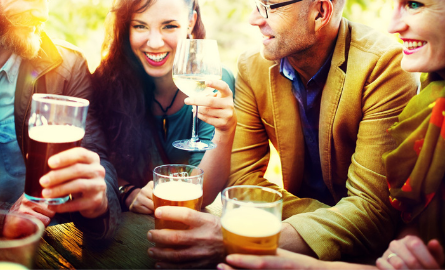 A group of people drinking beer and wine.