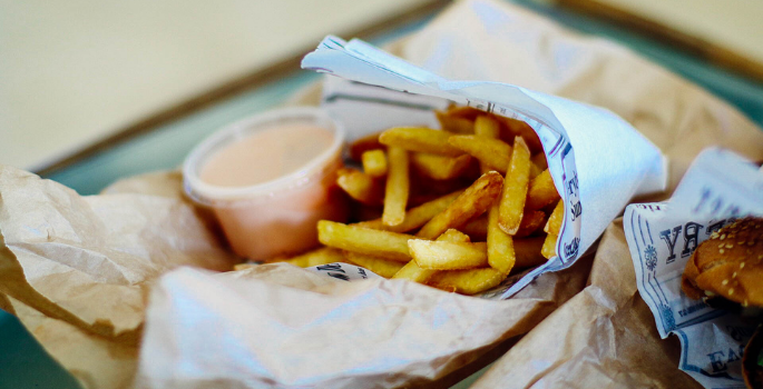 A tray of french fries and a burger from a food truck.