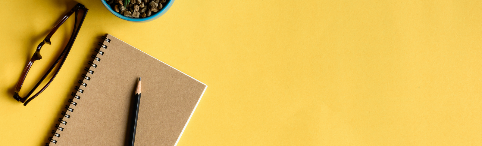 Notebook open on a yellow table.