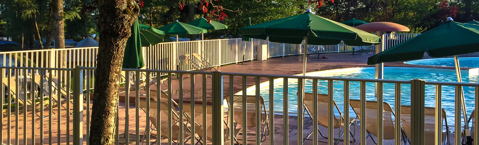 Fenced in outdoor in-ground pool.