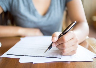 A person filling out an application form.