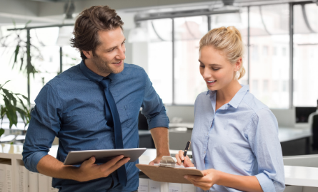 A person helping another person by showing them an iPad.
