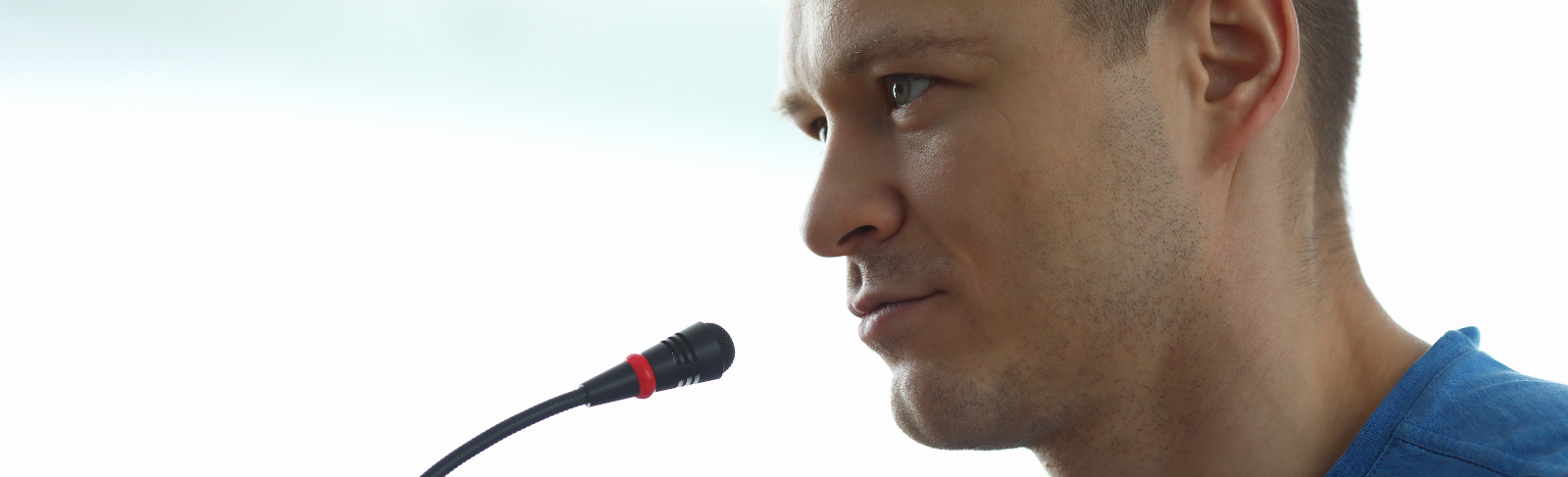 A man speaking into a mircrophone.