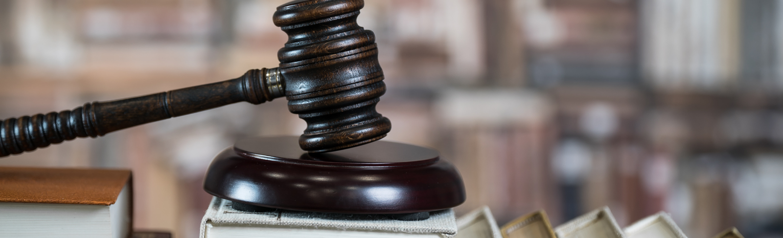 A gavel on top of a stack of books.