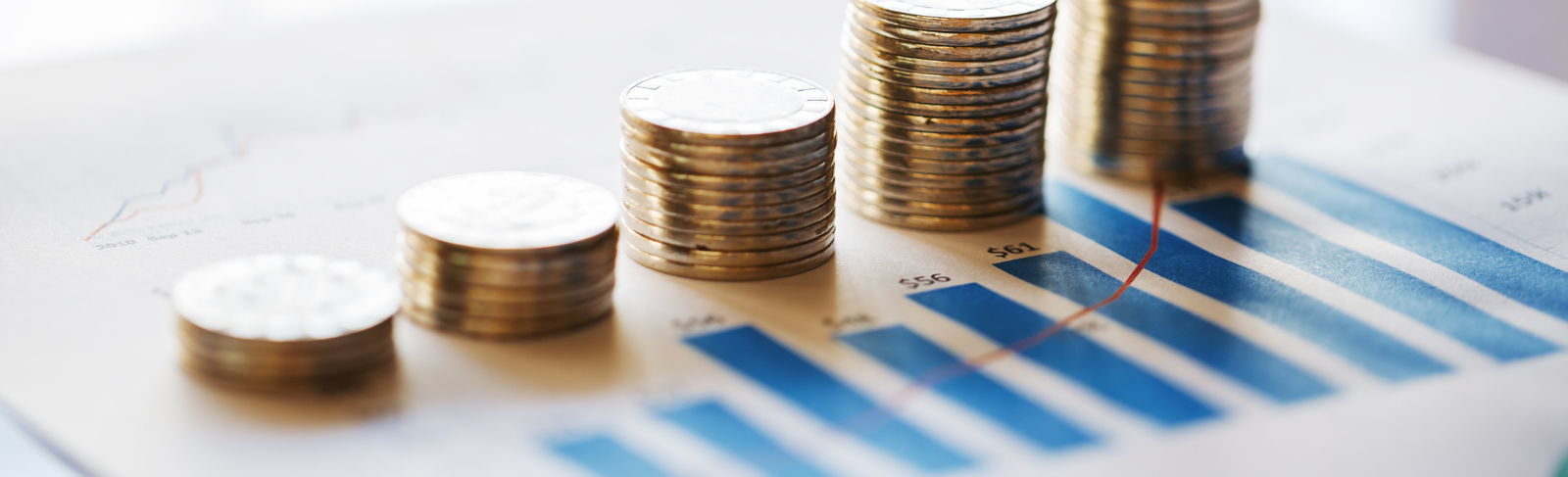 A stack on coins atop a financial worksheet.