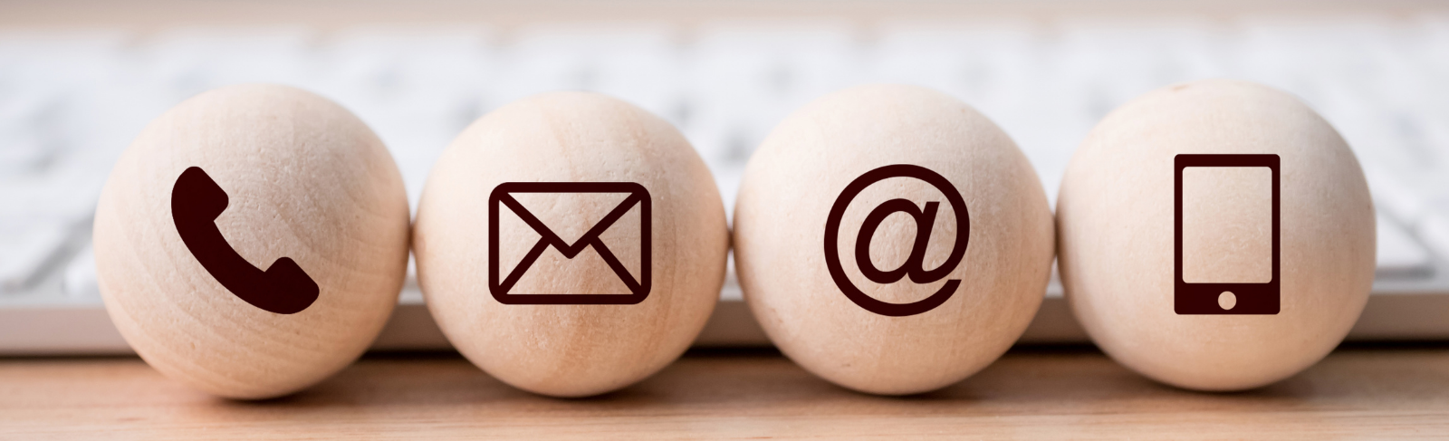 Wooden balls with various contact icons.