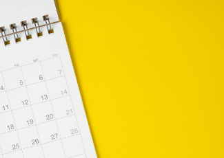 A calendar on top of a yellow background.
