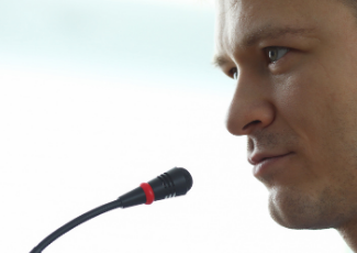 A person speaking into a microphone.