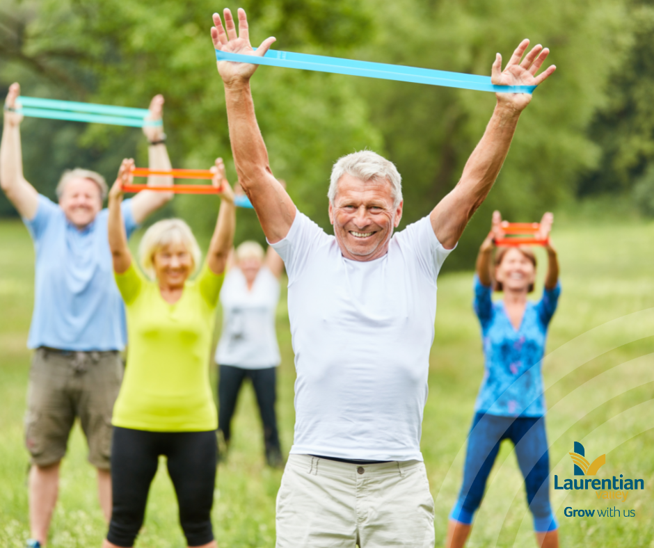 Group of 50+ adults exercising outside in summer.