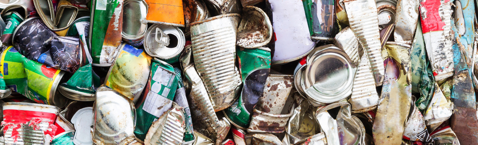 A pile of used recyclable plastics and cans.