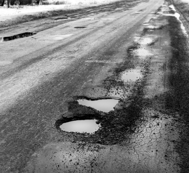 Road with various pot holes.