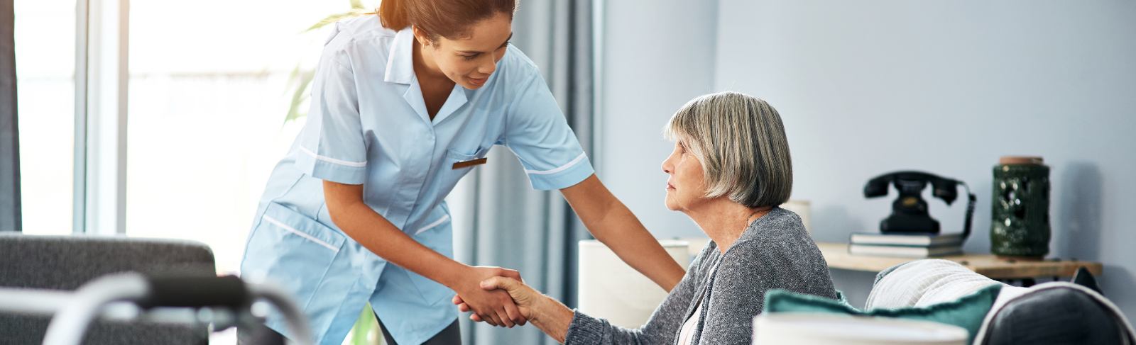 Health care worker helping an older woman. 