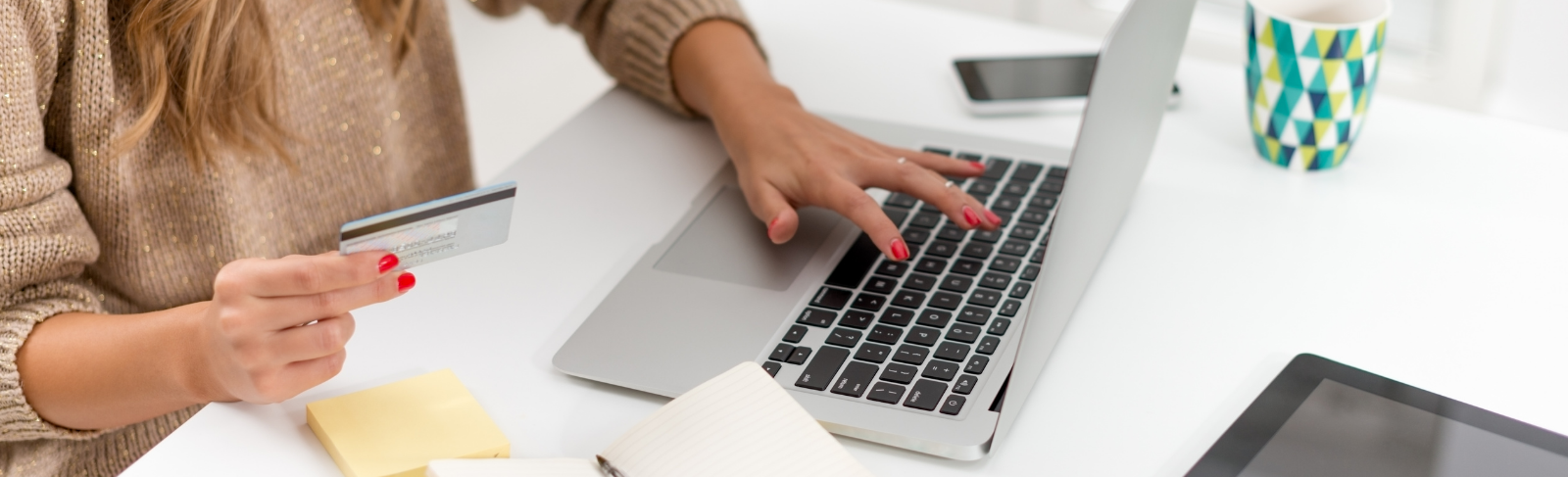 Female hand using a computer to pay for something online. 